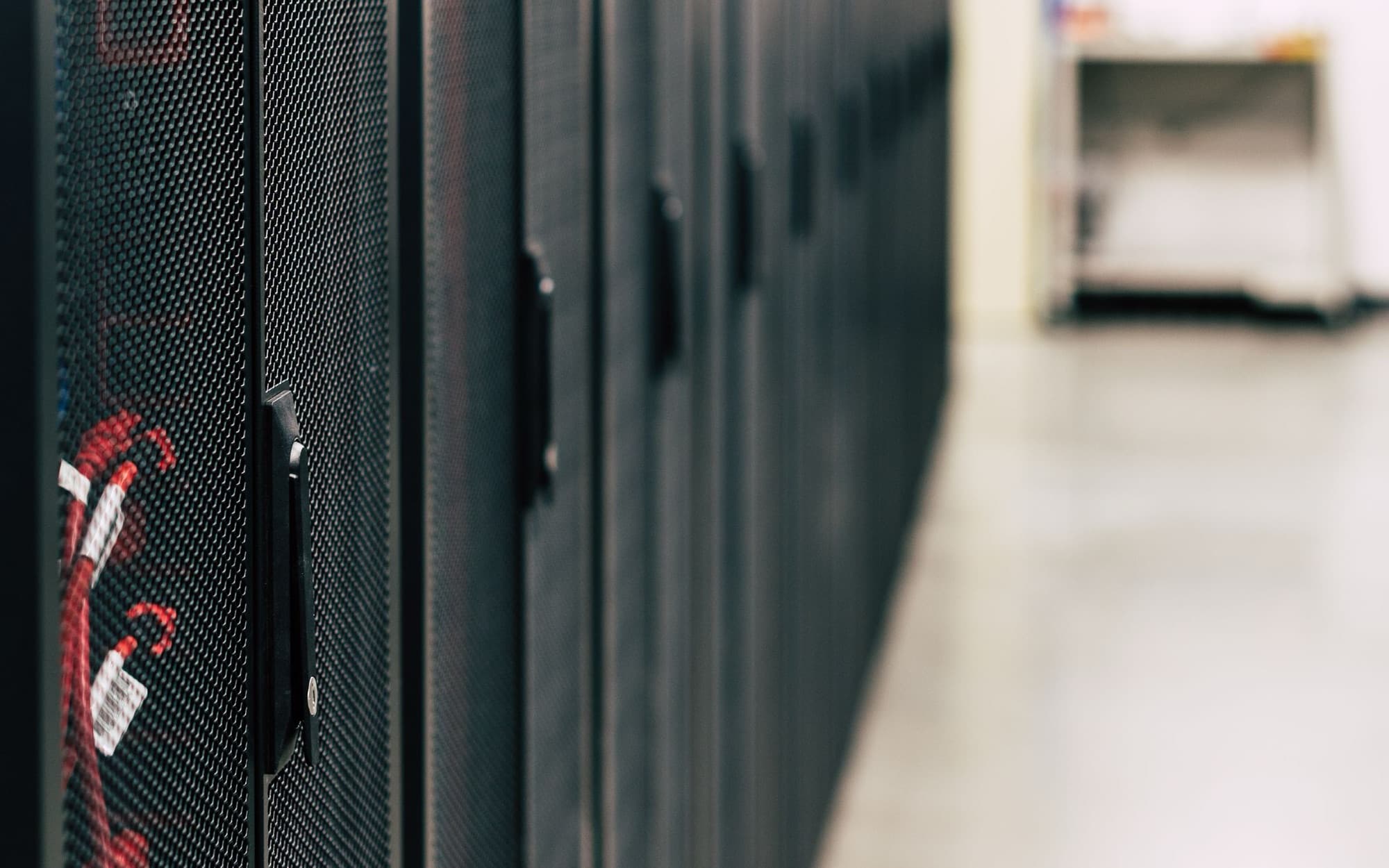 Row of rack cabinets along a data center aisle